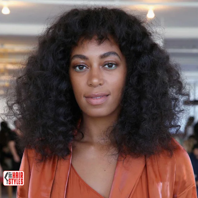 8. Afro Curls with Baby Bangs | 10 Best Curly Hairstyles With Bangs For A Stunning Look!